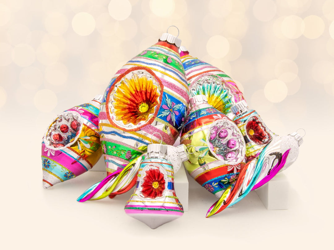 A mixed assortment of brightly colored and striped icicle and reflector tulip confetti ornaments.