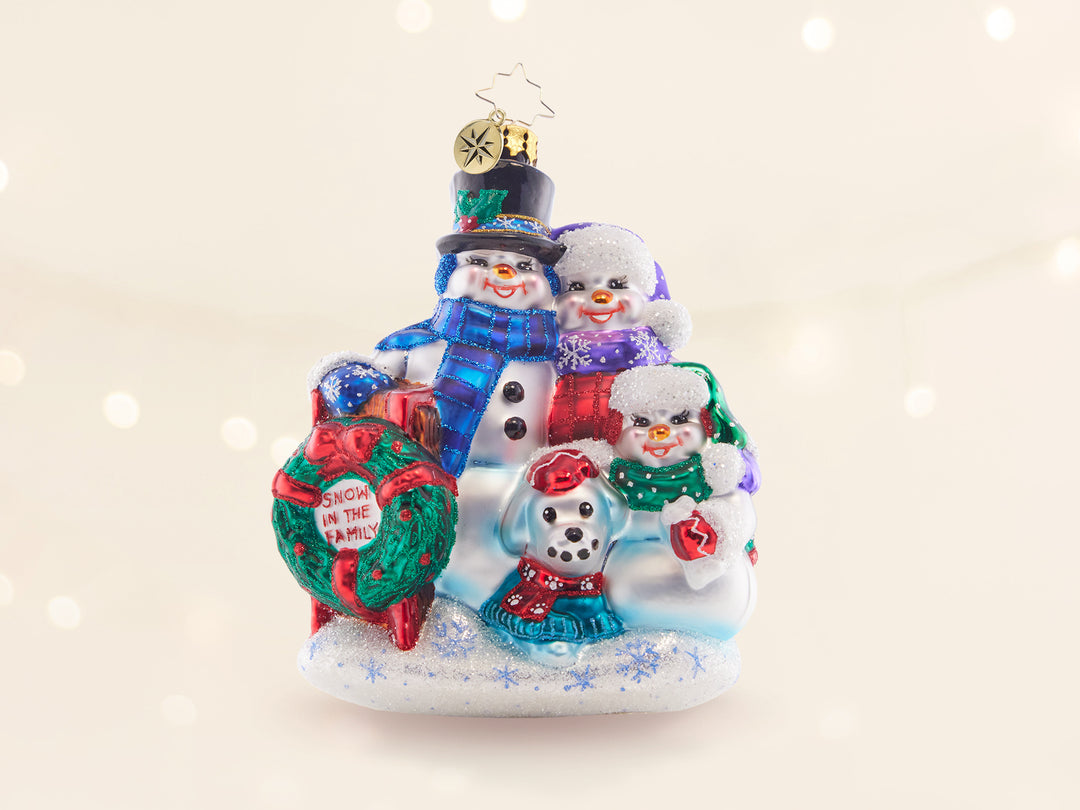 A snowman family ornament, complete with a snowdad, snowmom, snowchild, and snowdog.