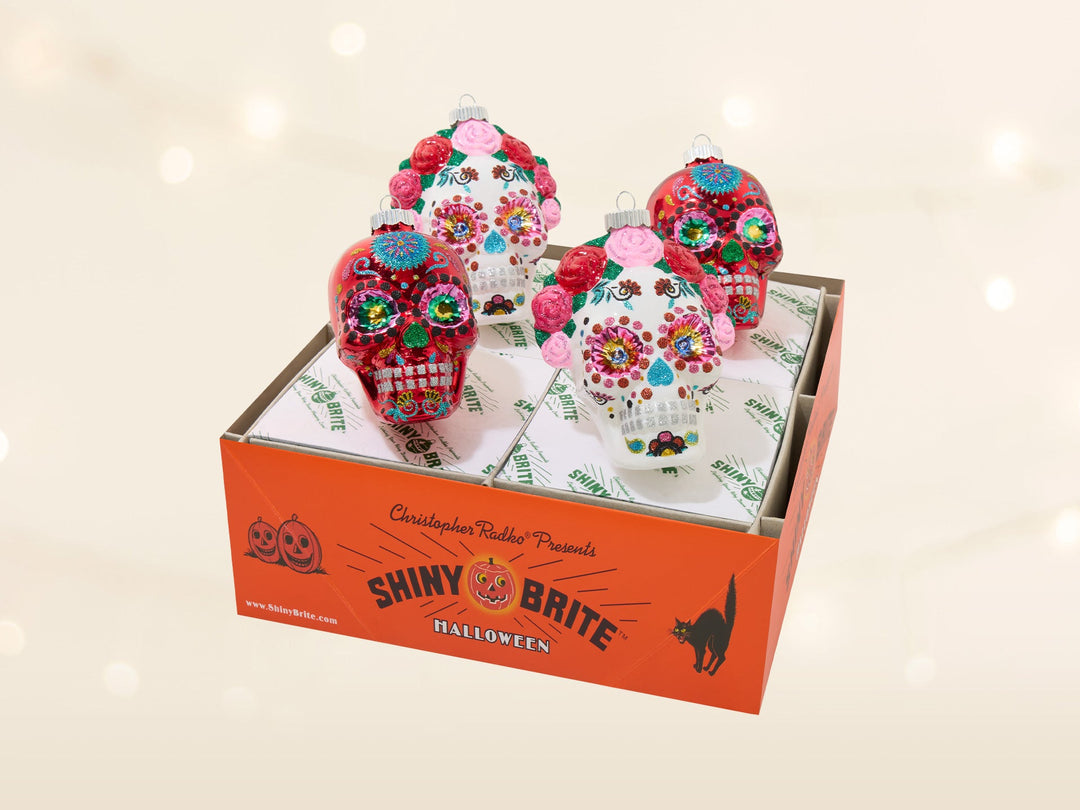 A mixed assortment of Día de Muertos skull ornaments. Some have flower crowns.