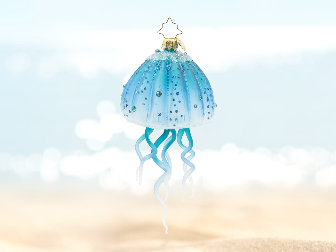 A blue jellyfish ornament with hanging tentacles.