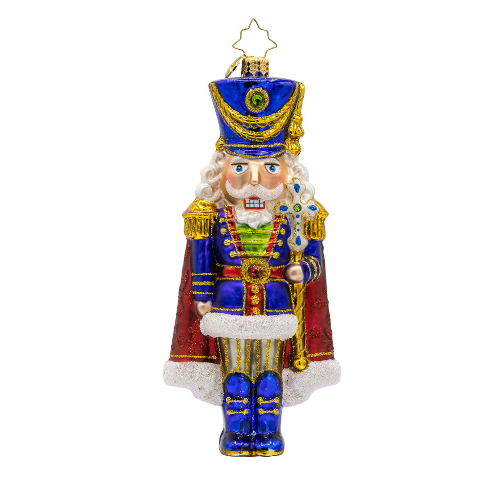 Long Coat Nutcracker ornament. Features elegant attire of regal blue and red accompanied by a dignified stance. View of front.