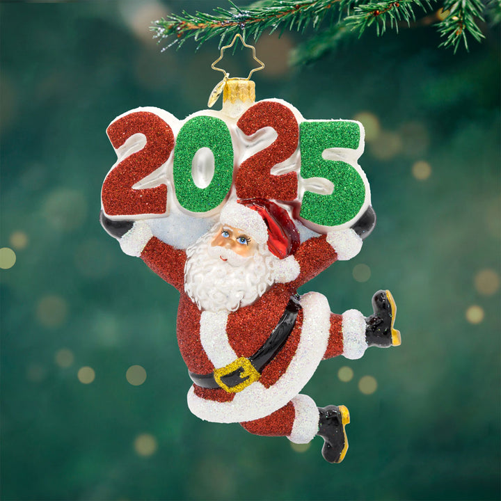 Santa's 2025 Countdown ornament. Santa is holding up the year 2025. View of front.