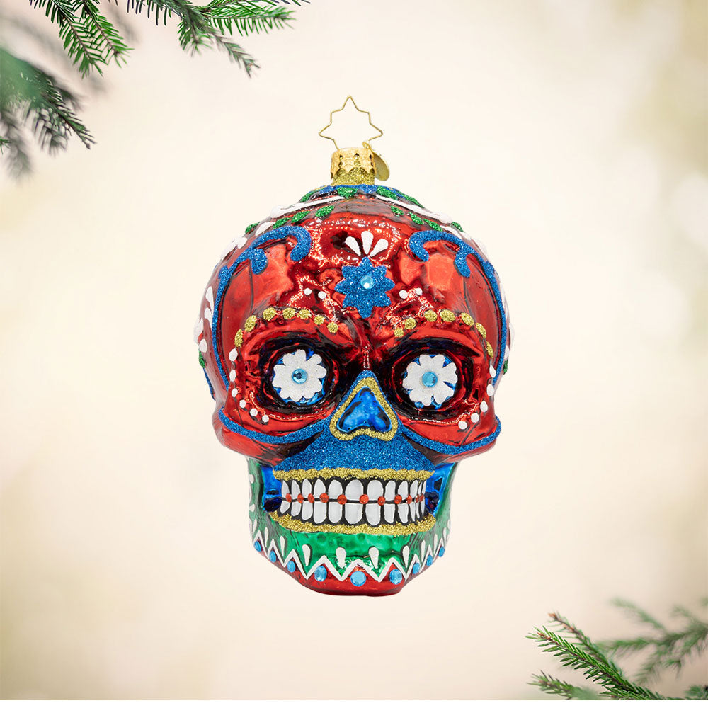 Calavera Fiesta ornament. Day of the Dead decorated skull with vibrant colors and intricate details. View of front.