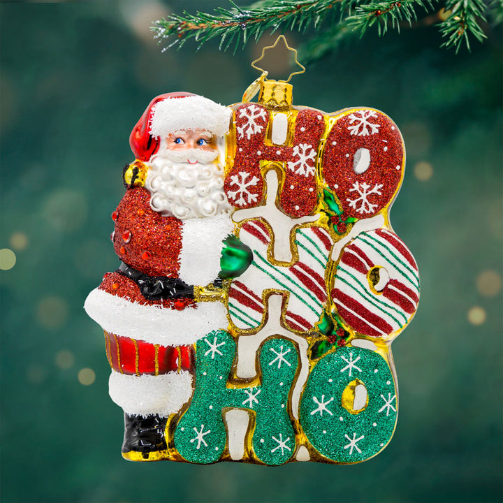 Merry Ho Ho Ho Santa ornament. Santa standing next a festively decorated "Ho Ho Ho." View of front.