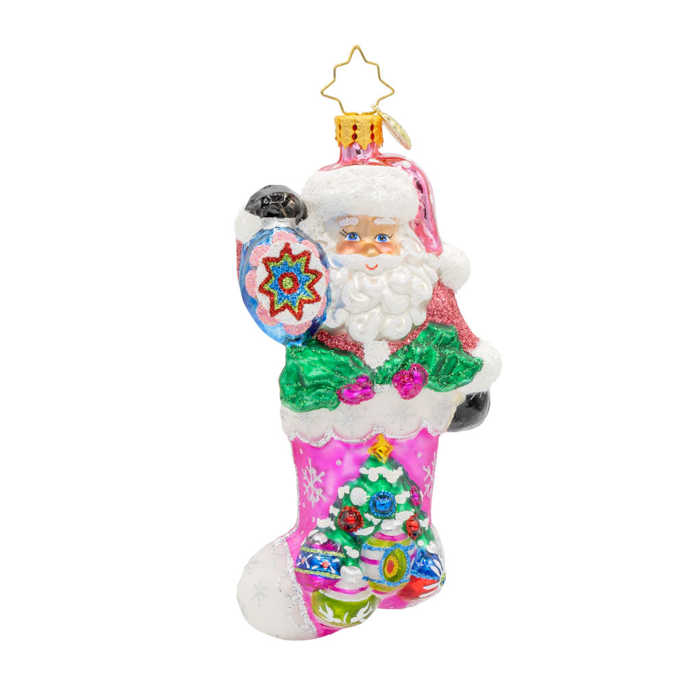 Santa's Stocking Stuffer ornament. Santa wears a shimmering pink suit and glittery hat. A colorful assortment of shiny brite ornaments adorn the stocking. View of front.