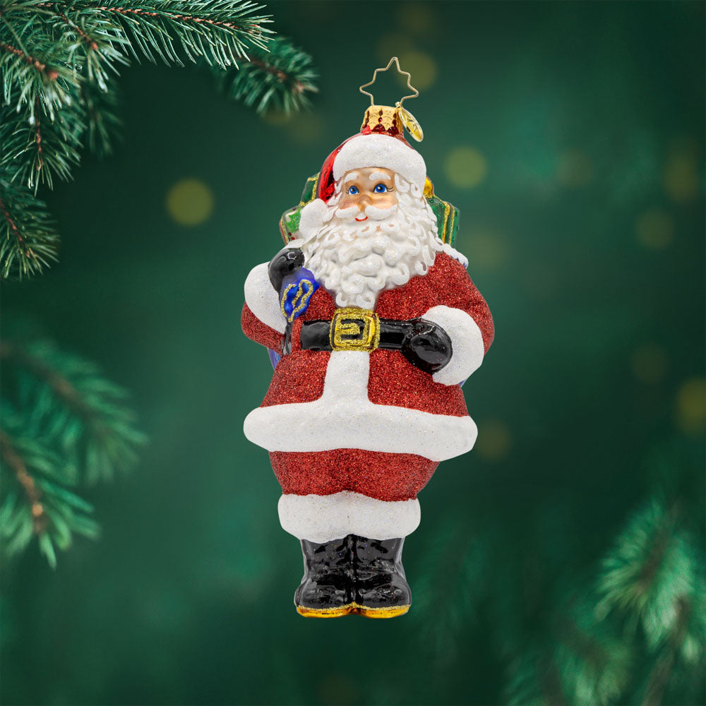 Jolly Old Kris Kringle ornament. Features Santa with his red suit, white beard, and bag of presents. View of front.