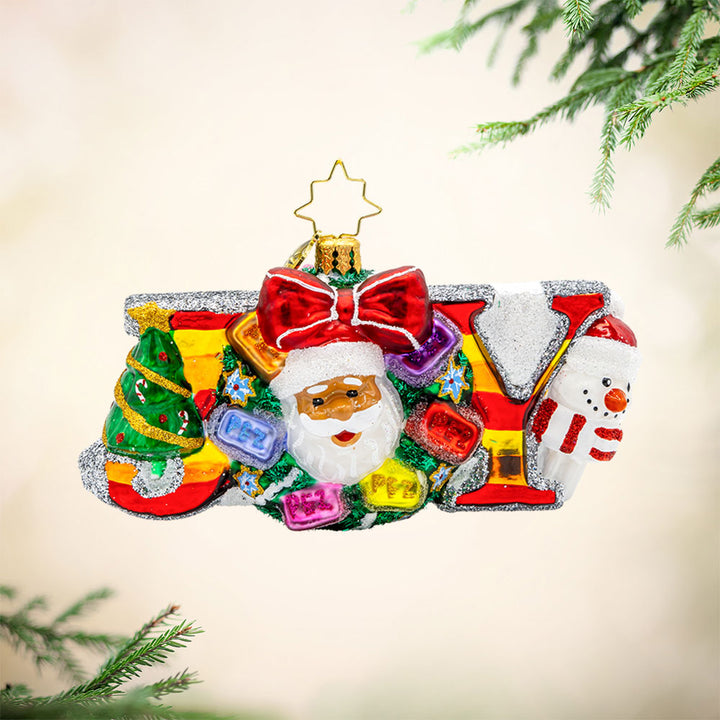 Joyful PEZ-mas Ornament. Featuring a festive wreath adorned with PEZ dispensers and a smiling Santa. View of front.