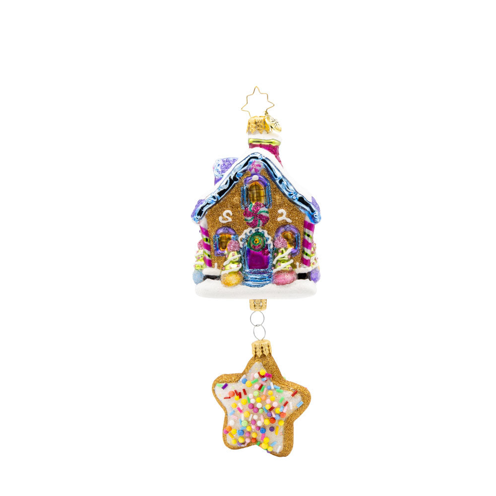 Sweet Beginnings ornament. A gingerbread house decorated in vibrant colors and candy. A gingerbread star cookie covered in sprinkles hangs below. View of front.