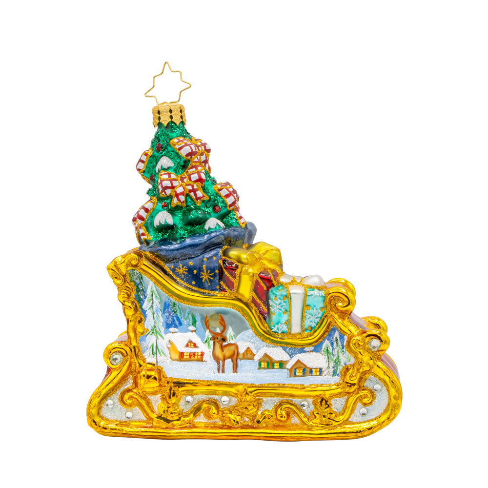 Enchanted Holiday Sleigh ornament. A beautifully crafted sleigh with intricate details, shimmering satin bows, and a hand-painted winter scene. View of left side.
