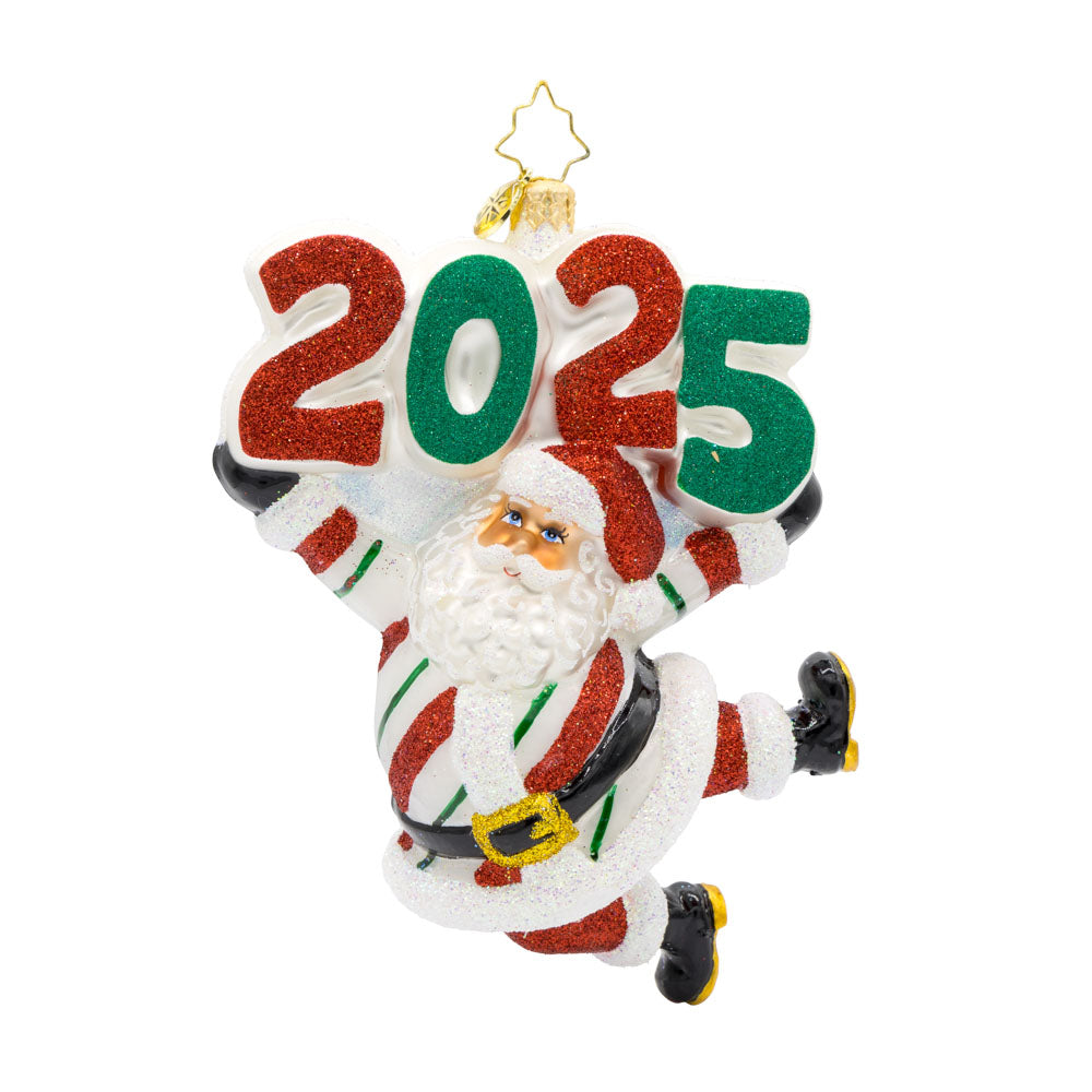 Peppermint St. Nick Ornament.  Santa is dressed in a peppermint-striped suit, complete with a shiny hat, mittens, and a touch of glitter. "2025" is held above his head in similar colors. View of front.