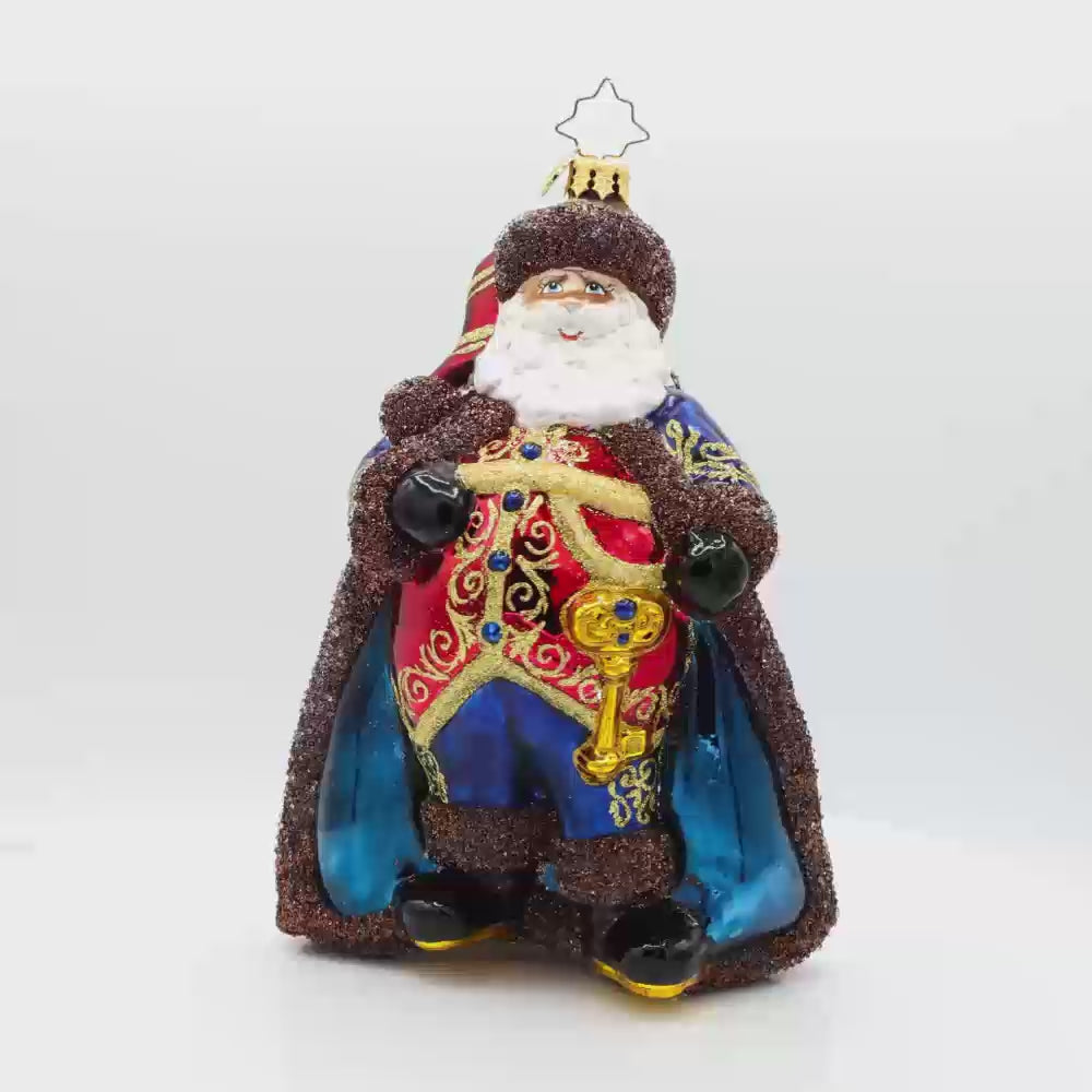 Keymaster Klaus ornament. Decked in a lush burgundy coat with champagne glitter accents and an intricate key motif. Video.