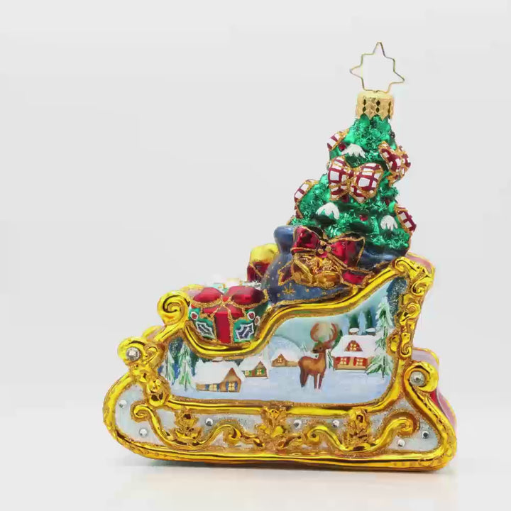Enchanted Holiday Sleigh ornament. A beautifully crafted sleigh with intricate details, shimmering satin bows, and a hand-painted winter scene. Video.