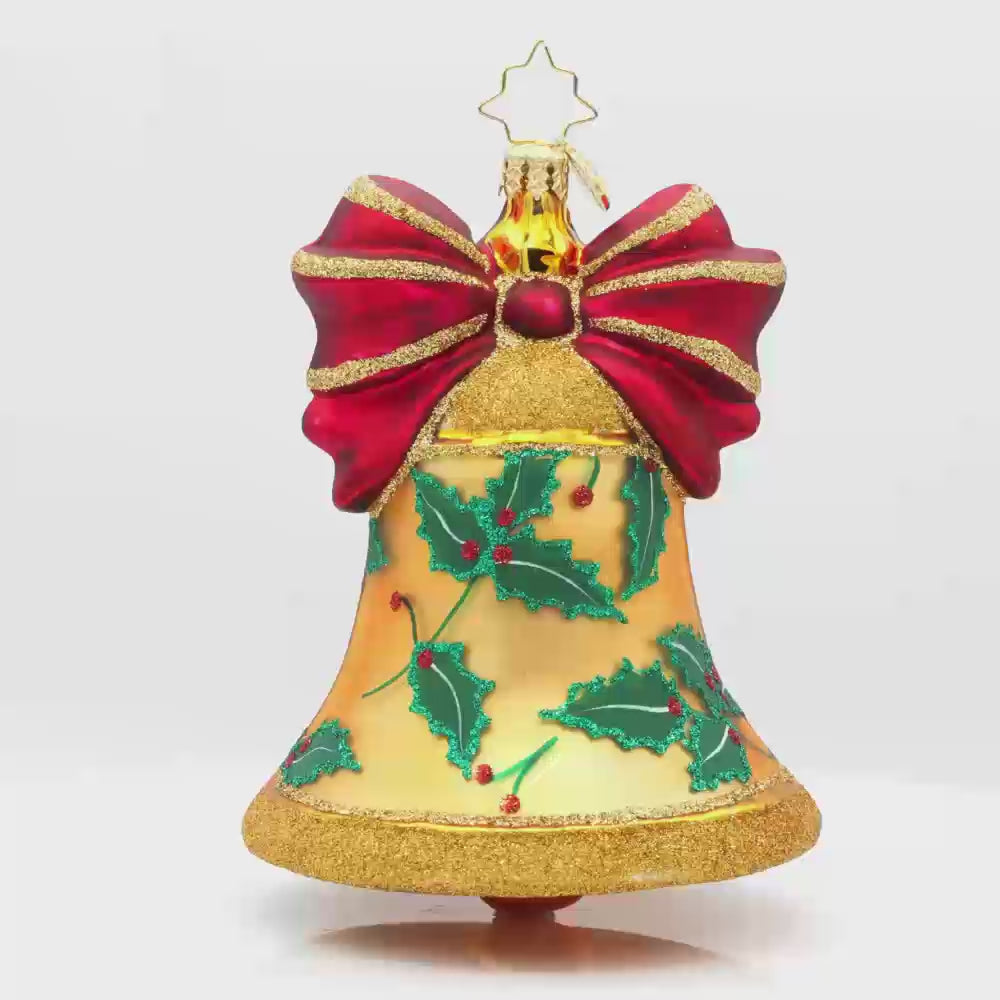 Bell Bliss ornament. A glittery gold bell donned with a red ribbon and hand-painted holly. Video.
