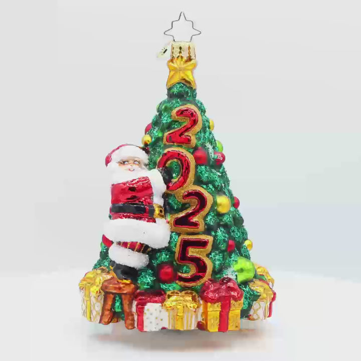 Santa's 2025 Tree Trim. Santa is seen decorating the Christmas tree with all the trimmings. Tree is dated with "2025." Video.