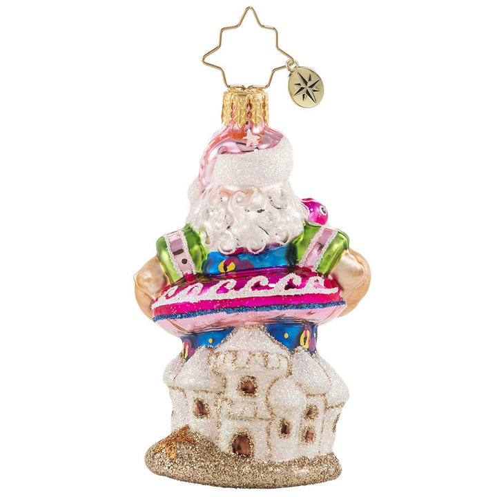 Back - Ornament Description - Out of Office Santa Gem: After his jam-packed holiday season, Santa is relaxing on a well-deserved vacation! He has traded his fur suit for swim shorts and his sack for a flamingo floatie-- he is looking ready for some off-duty fun in the sun!