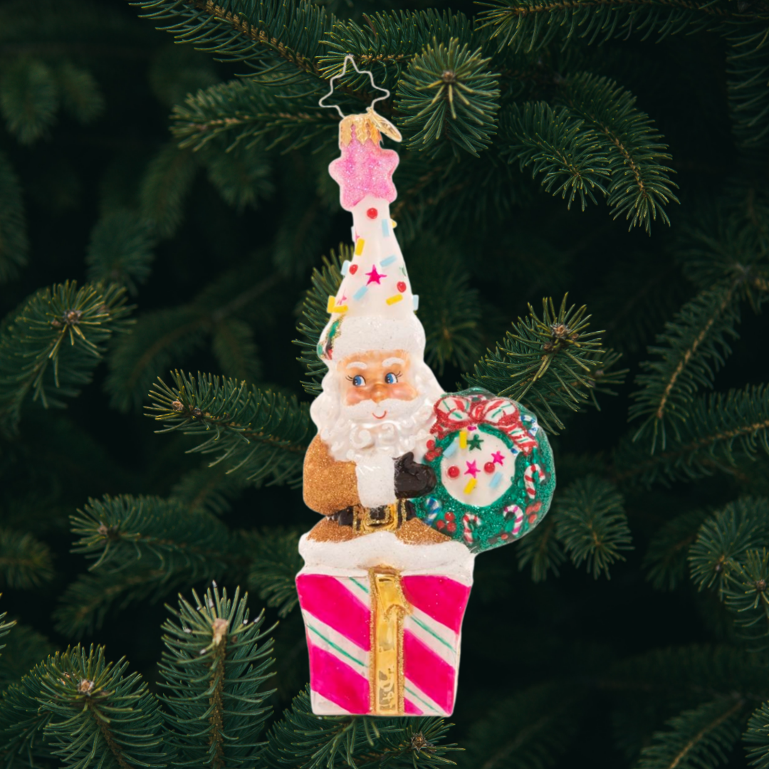 Ornament Description - Christmas Confetti Santa: Santa looks ready to party! Donning a fun and colorful hat topped with candy sprinkles and a shimmering pink star, he's hoping your holiday season is extra sweet!