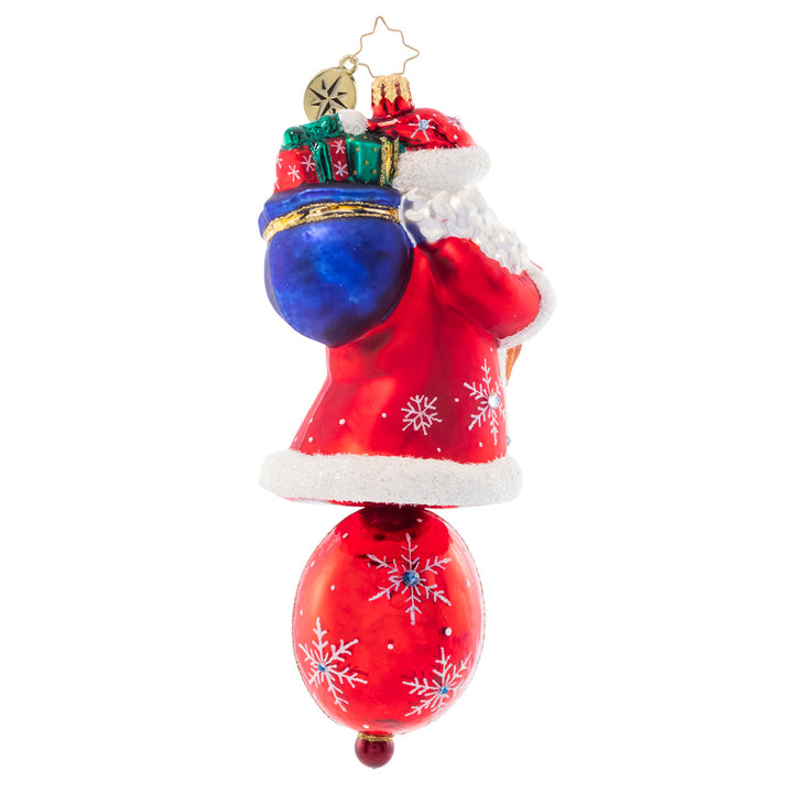 Back - Ornament Description - Christmas Charm Claus: Dressed head-to-toe in red robes and sparkling stars, this trustworthy Santa is the perfect guiding light to lead you through Christmas night.