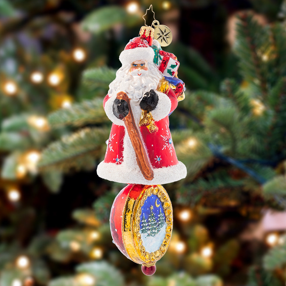 Ornament Description - Christmas Charm Claus: Dressed head-to-toe in red robes and sparkling stars, this trustworthy Santa is the perfect guiding light to lead you through Christmas night.