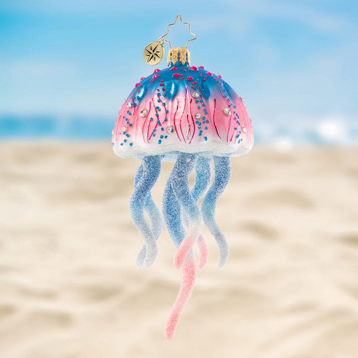 Ornament Description - Colorful Jelly: This joyful jellyfish is a jubilee of pink and blue hues. Let this stunning sea creature float among the boughs of the tree, bringing nautical cheer for all to see!