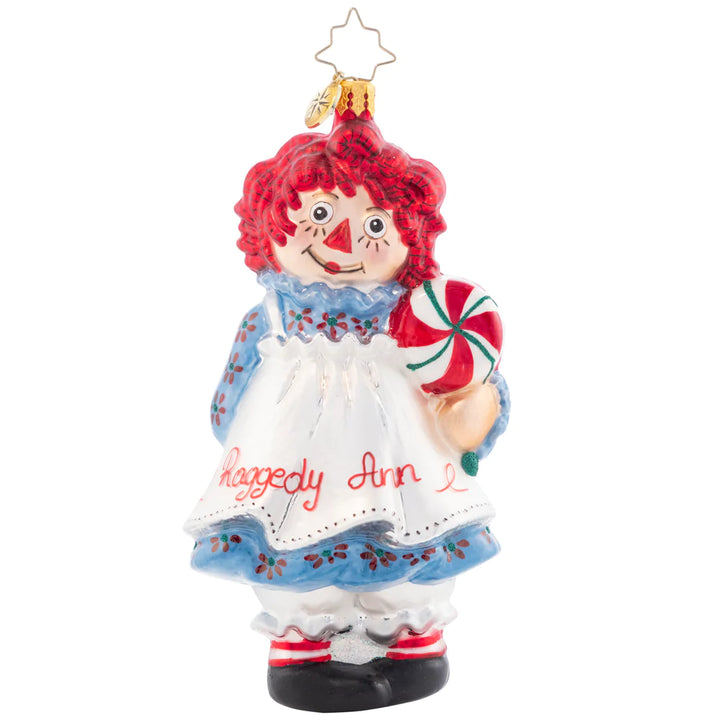 Front - Ornament Description - Raggedy Sweets: This timeless sweetie has her own sweets this Christmas. Share the love and childlike wonder this season with Raggedy Ann. She got all "dolled" up for you in her best holiday dress and apron!