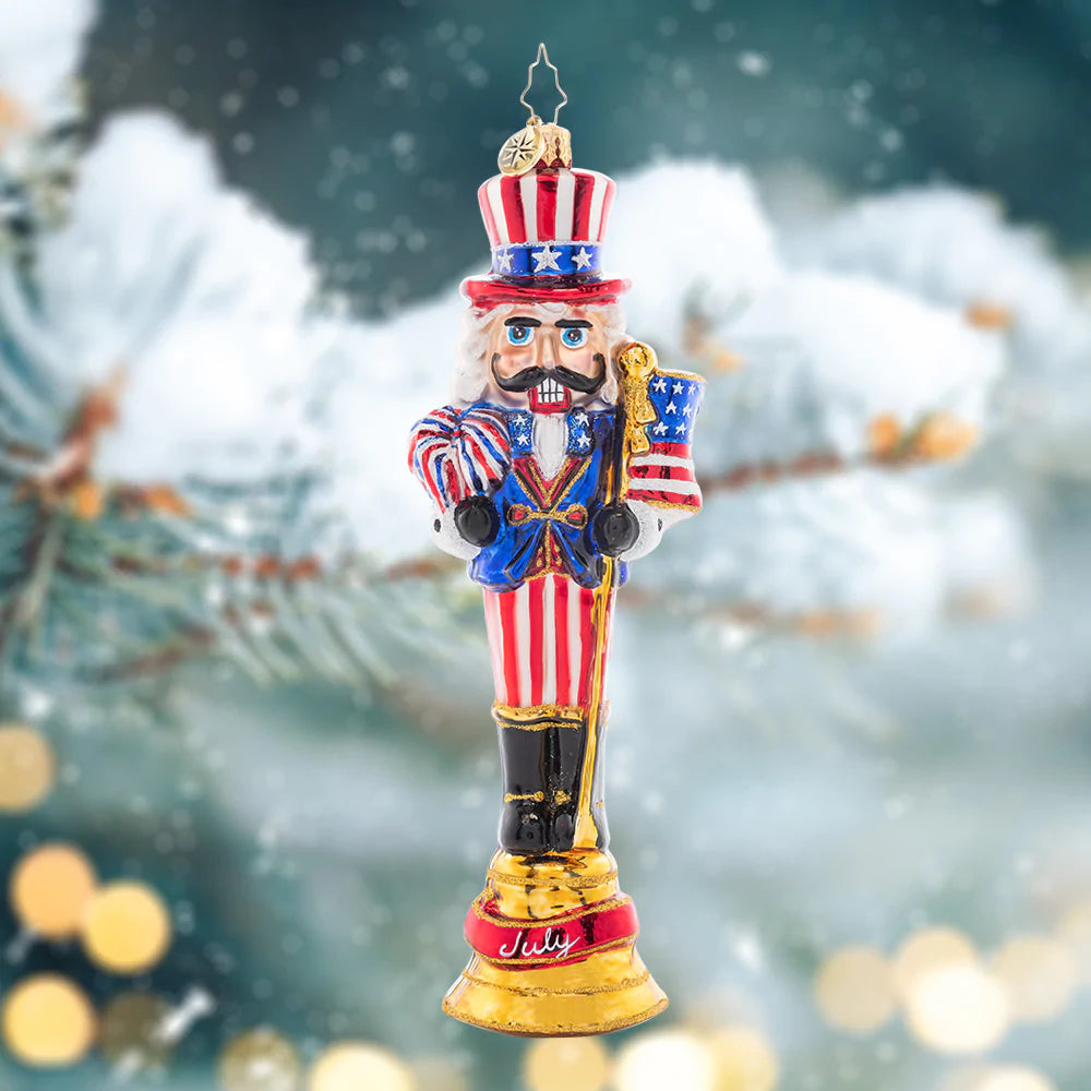 Ornament Description - Fireworks For The Fourth: Celebrate the land of the free with this patriotic nutcracker! The seventh piece in our Ornament of the month collection proudly sports a festive suit of red, white, and blue.