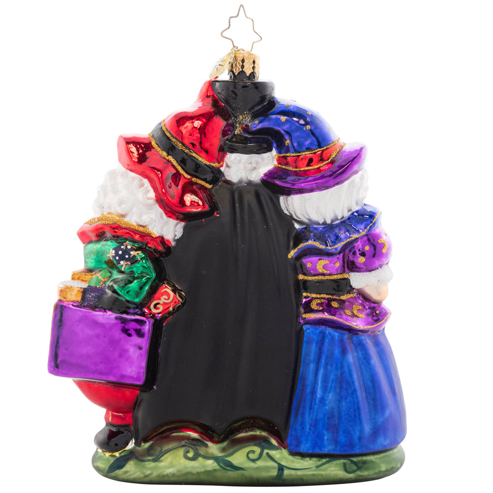 Back - Ornament Description - Happy Hauntings: It's looking like a holiday-themed Halloween! Santa, Mrs. Claus, and a spooky nutcracker celebrate with fright and delight for the tenth piece in our Ornament of the Month collection.