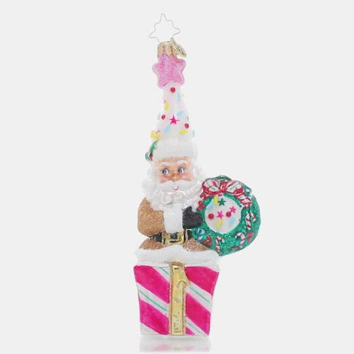 Video - Ornament Description - Christmas Confetti Santa: Santa looks ready to party! Donning a fun and colorful hat topped with candy sprinkles and a shimmering pink star, he's hoping your holiday season is extra sweet!
