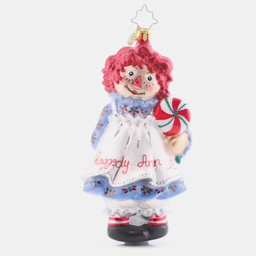 Video - Ornament Description - Raggedy Sweets: This timeless sweetie has her own sweets this Christmas. Share the love and childlike wonder this season with Raggedy Ann. She got all "dolled" up for you in her best holiday dress and apron! This video shows the ornament spinning slowly.