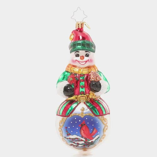 Video - Ornament Description - Guardian of the Forest: Many animals avoid the cold winters by hibernating or migrating to warmer weather. This snowman celebrates his friend the cardinal, who chooses to stay – and wears a festive red coat for the occasion! This video shows the ornament slowly spinning.