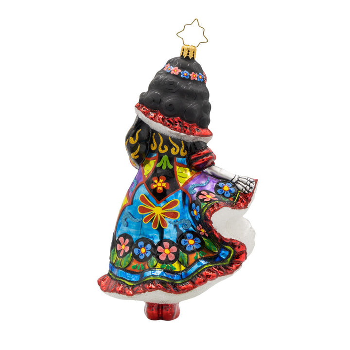 With her colorful dress, shimmering skull, and graceful pose, this vibrant Day of the Dead dancer is ready to take center stage! View of back of ornament.