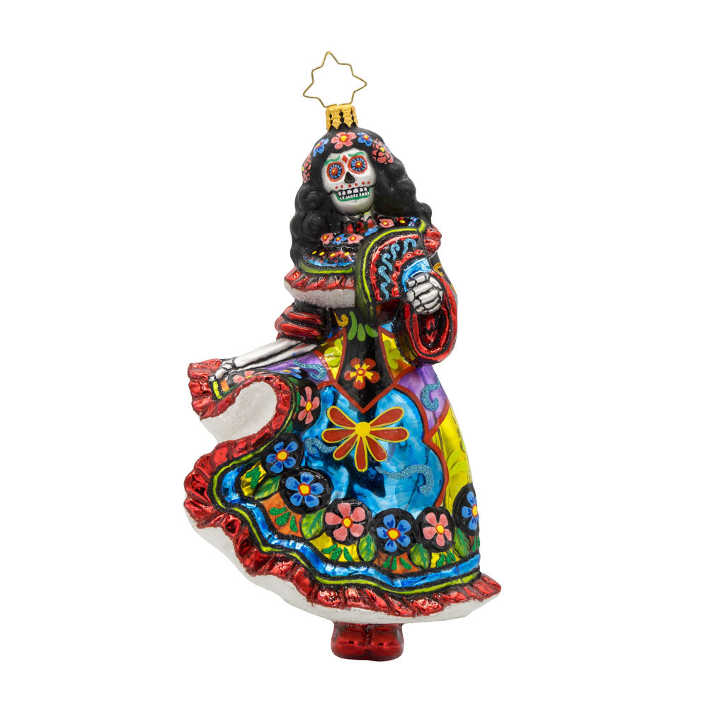 With her colorful dress, shimmering skull, and graceful pose, this vibrant Day of the Dead dancer is ready to take center stage! View of front of ornament.