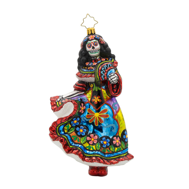 With her colorful dress, shimmering skull, and graceful pose, this vibrant Day of the Dead dancer is ready to take center stage! View of front of ornament.