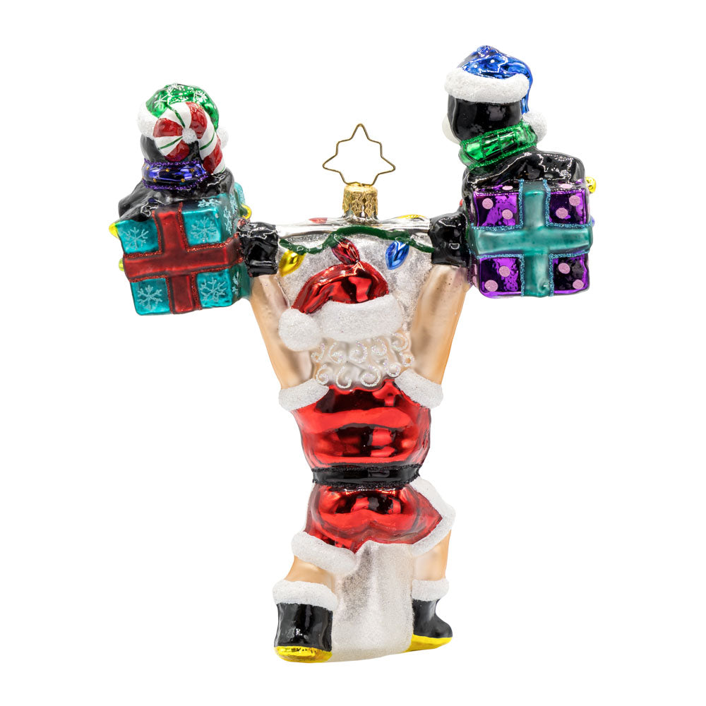 Jolly Liftmas ornament. Santa overhead presses two penguin's atop gifts. Sporting an athletic variation on his red Christmas suit! View of back.