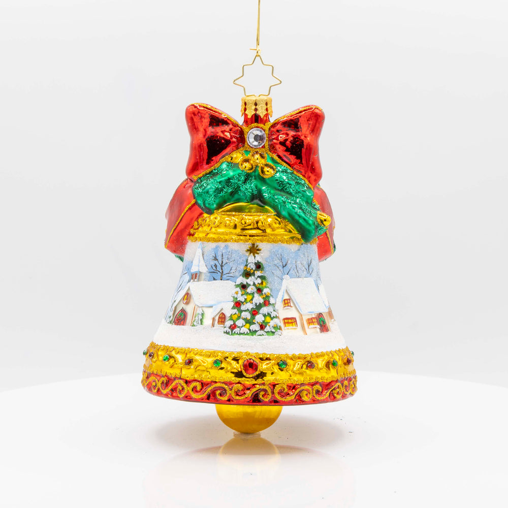 Adorned with a beautiful winter scene, sparkling gems, and a festive ribbon, this Scenic Chimes ornament is the perfect way to add a touch of magic to your Christmas tree. View of front.