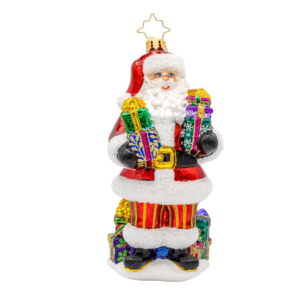 Santa's Stocking Stuffers ornament. Santa wearing his classic red suit, has presents stacked in both arms and around his feet. View of front.