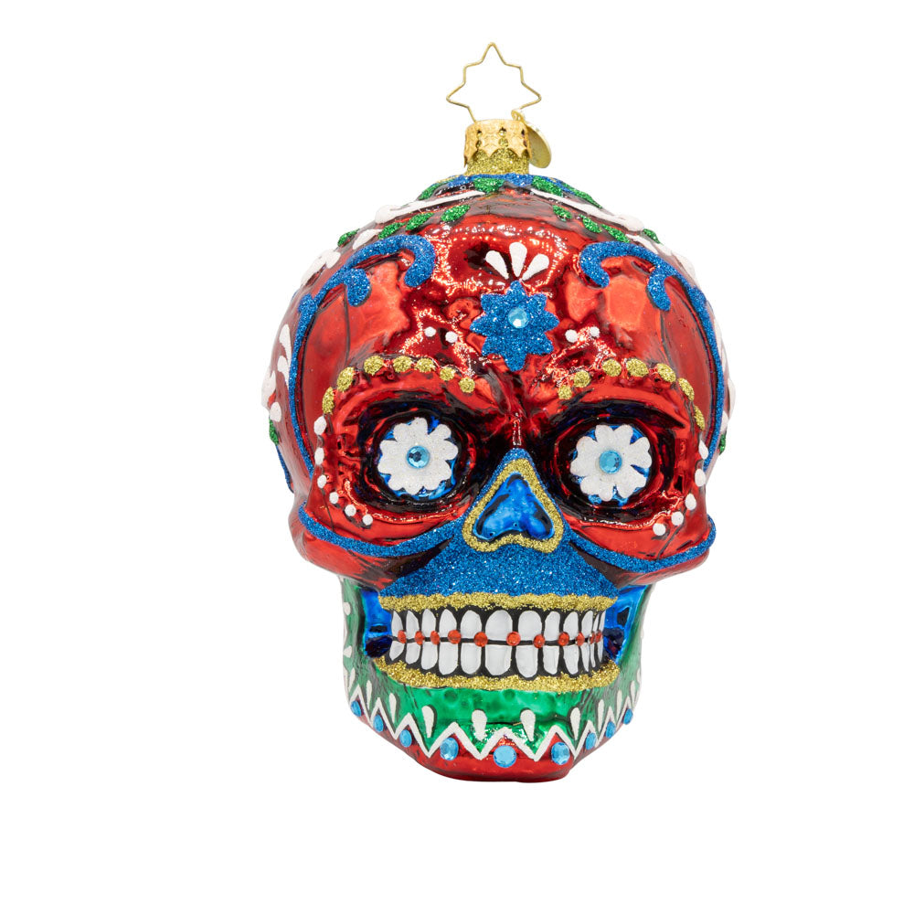 Calavera Fiesta ornament. Day of the Dead decorated skull with vibrant colors and intricate details. View of front.