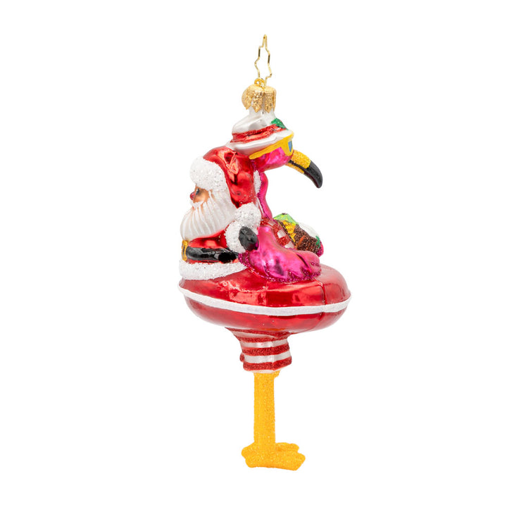 Floatin' Flamingo Fun ornament. Features a flamingo relaxing on a Santa tube, sipping from a coconut. View of left side.