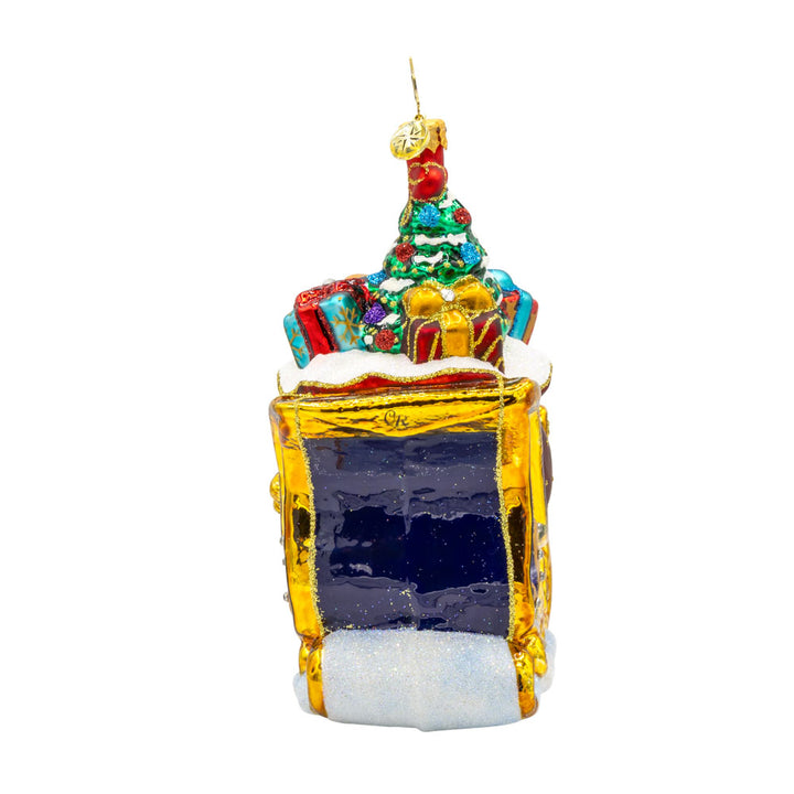 Celebratory Sleighride ornament. Royal Blue and gold sleigh, adorned with shimmering jewels and regal ribbons. View of left side.