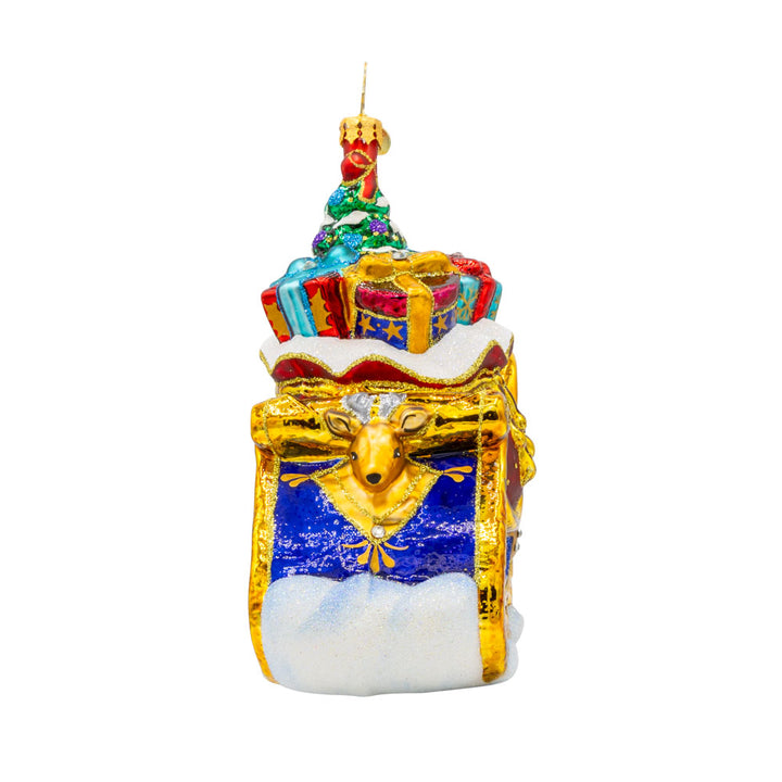Celebratory Sleighride ornament. Royal Blue and gold sleigh, adorned with shimmering jewels and regal ribbons. View of right side.