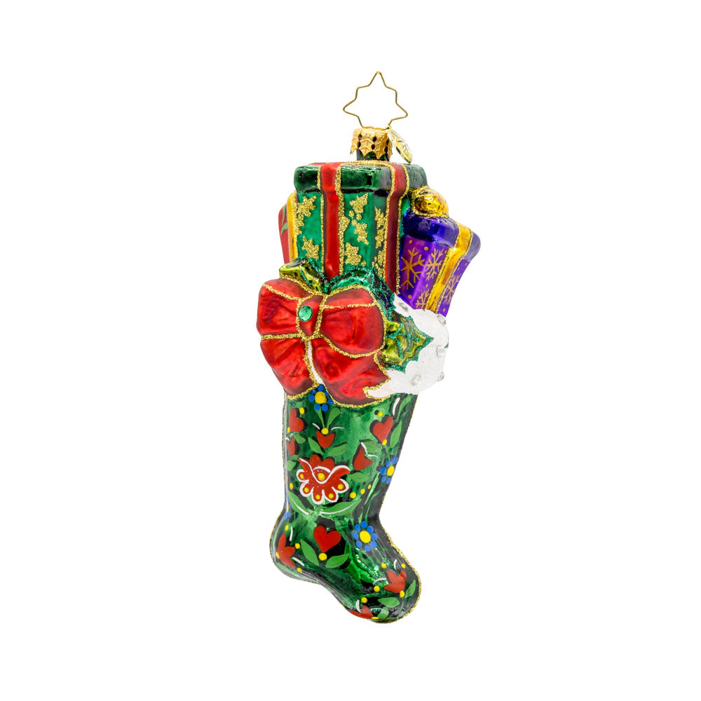 Folklore Charm ornament. This emerald, green stocking is adorned with intricate folk art designs, vibrant colors, and gifts coming out the top. View of back.