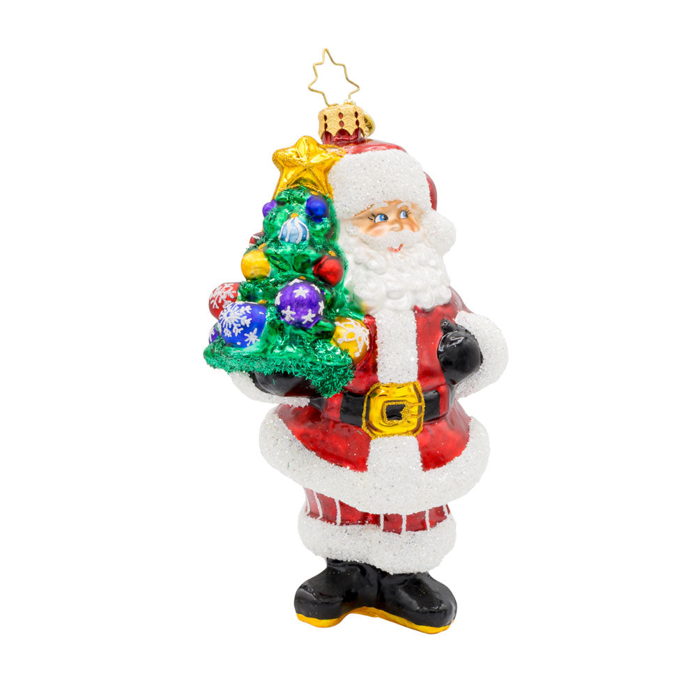 Tree-Totin' Santa ornament. Santa carries a mini decorated Christmas tree.  View of front.