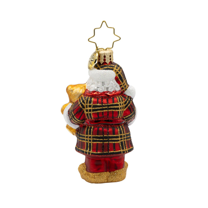 Sweet Slumber Treat Gem ornament. Santa is seen dressed in a plaid red, gold, and black robe. Tedd bear in hand and a mug of hot cocoa in the other. View of back.