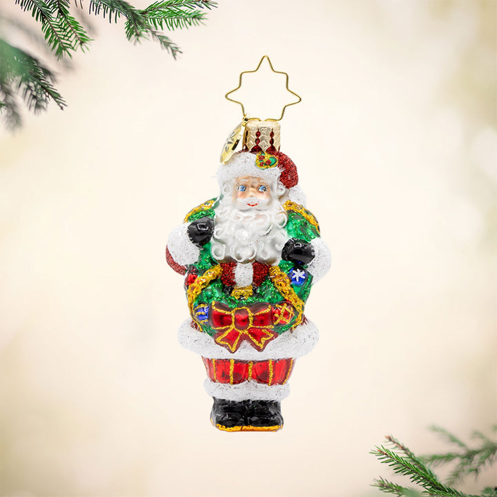 Wreath Wrangler Claus Gem ornament. Santa is seen here with a decorated Christmas wreath around his neck. View of front. 