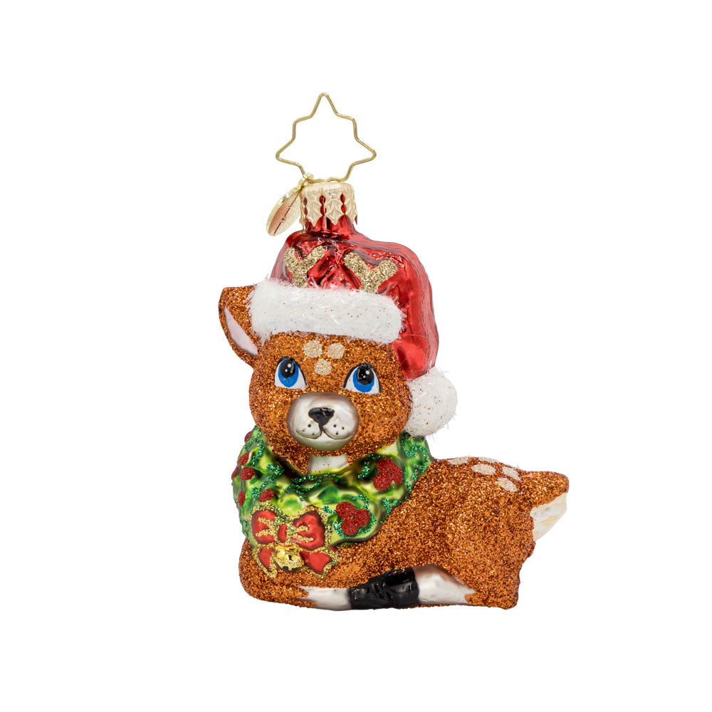 Fawning Over the Holidays Gem ornament. A laying fawn crowned with a wreath and Santa hat. View of front. 