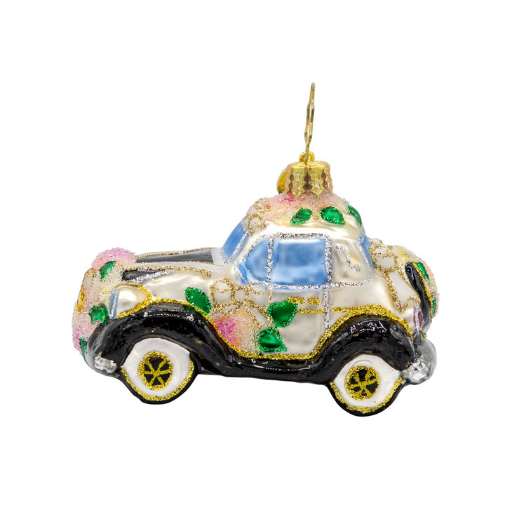 Wedding Day Wheels Gem ornament. A black and white car adorned with pink flowers and white bows. View of back.