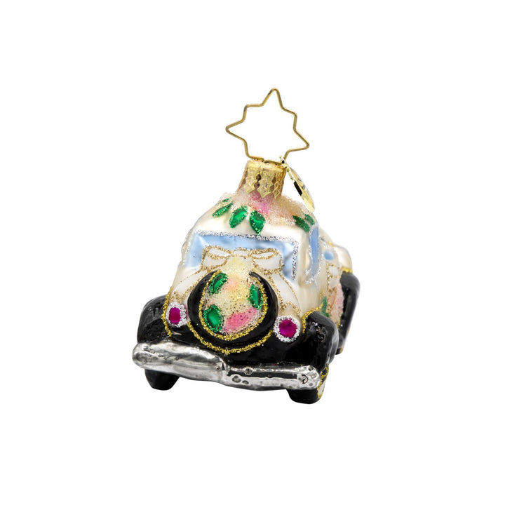 Wedding Day Wheels Gem ornament. A black and white car adorned with pink flowers and white bows. View of left side.