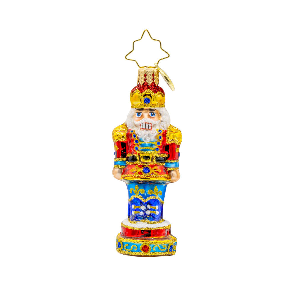 Royal Elegance Nutcracker Gem ornament. This nutcracker dons a red, blue, and gold suit. View of front. 