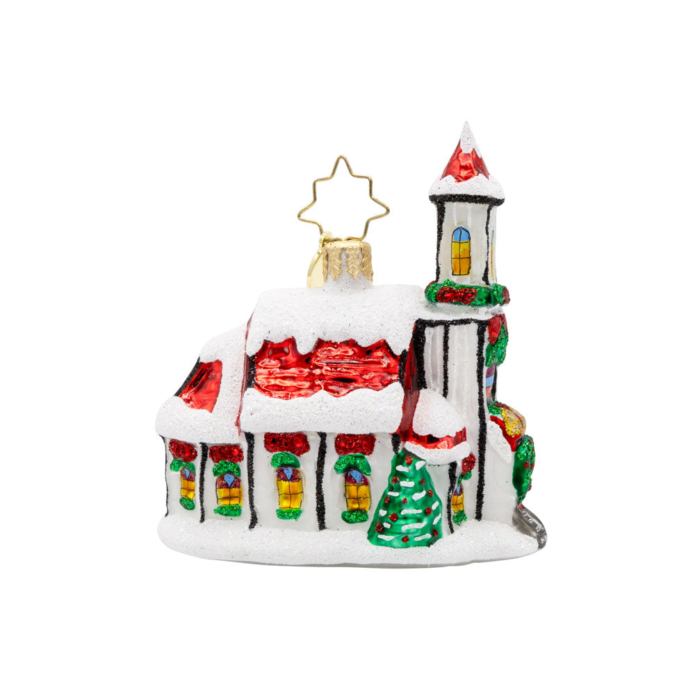 Holly Bell Chapel Gem ornament. A snow-covered chapel with a red roof adorned with wreathes galore. View of left side.