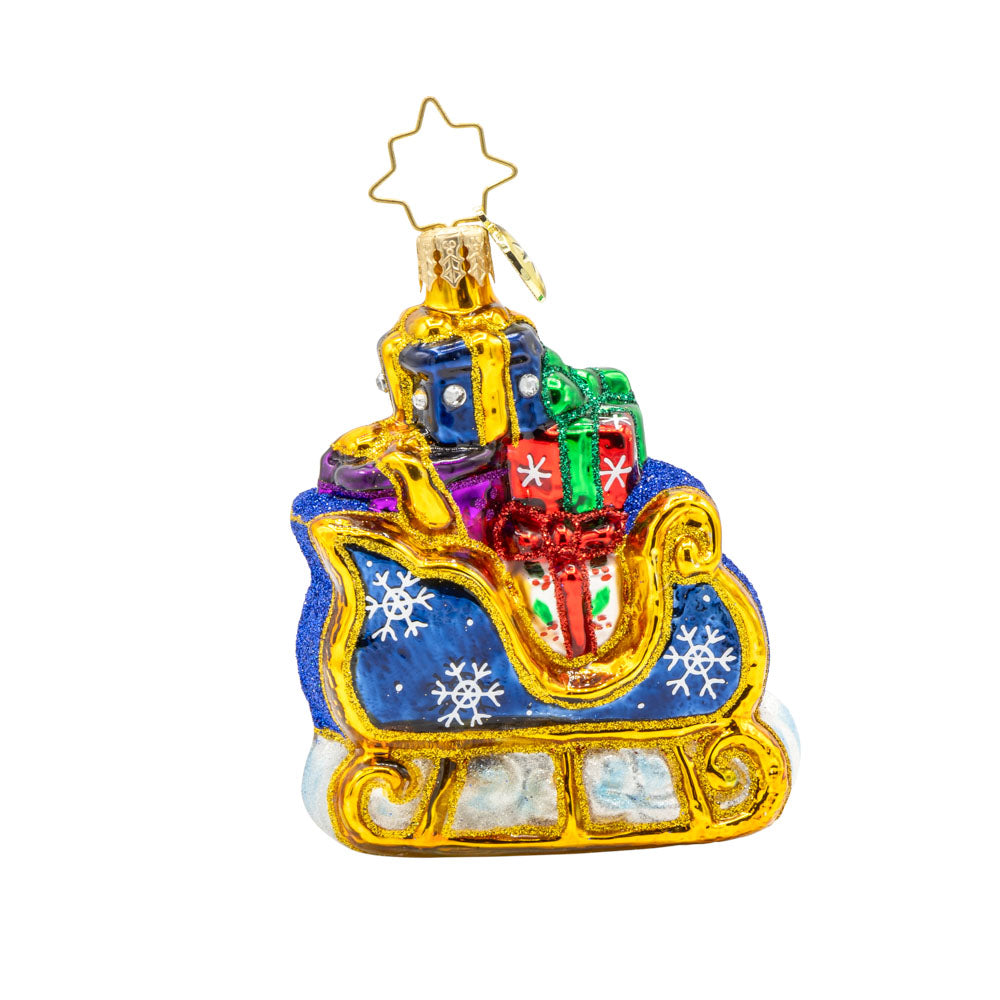 Starry Night Sleigh Gem ornament. A blue sleigh with gold trim, piled high with gifts. View of front. 