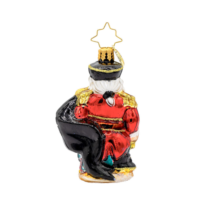 Swashbuckler Santa Gem ornament. Santa is dressed as a pirate, captains coat and eyepatch included. He sits atop a treasure chest with a pirate's flag in hand. View of back.